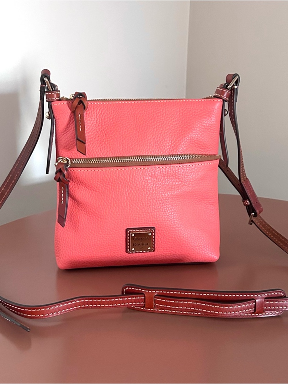 Dooney & Bourke Coral-Pink Pebbled Leather Crossbody with Brown Trim